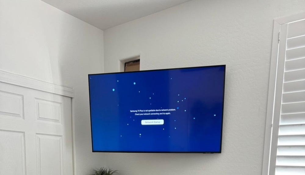 Bedroom TV mounted in the corner